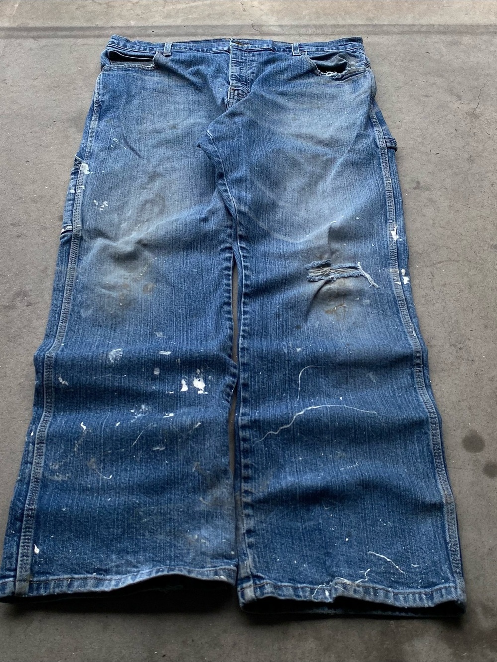 Baggy faded Dickies carpenter medium wash denim jeans with paint splatter